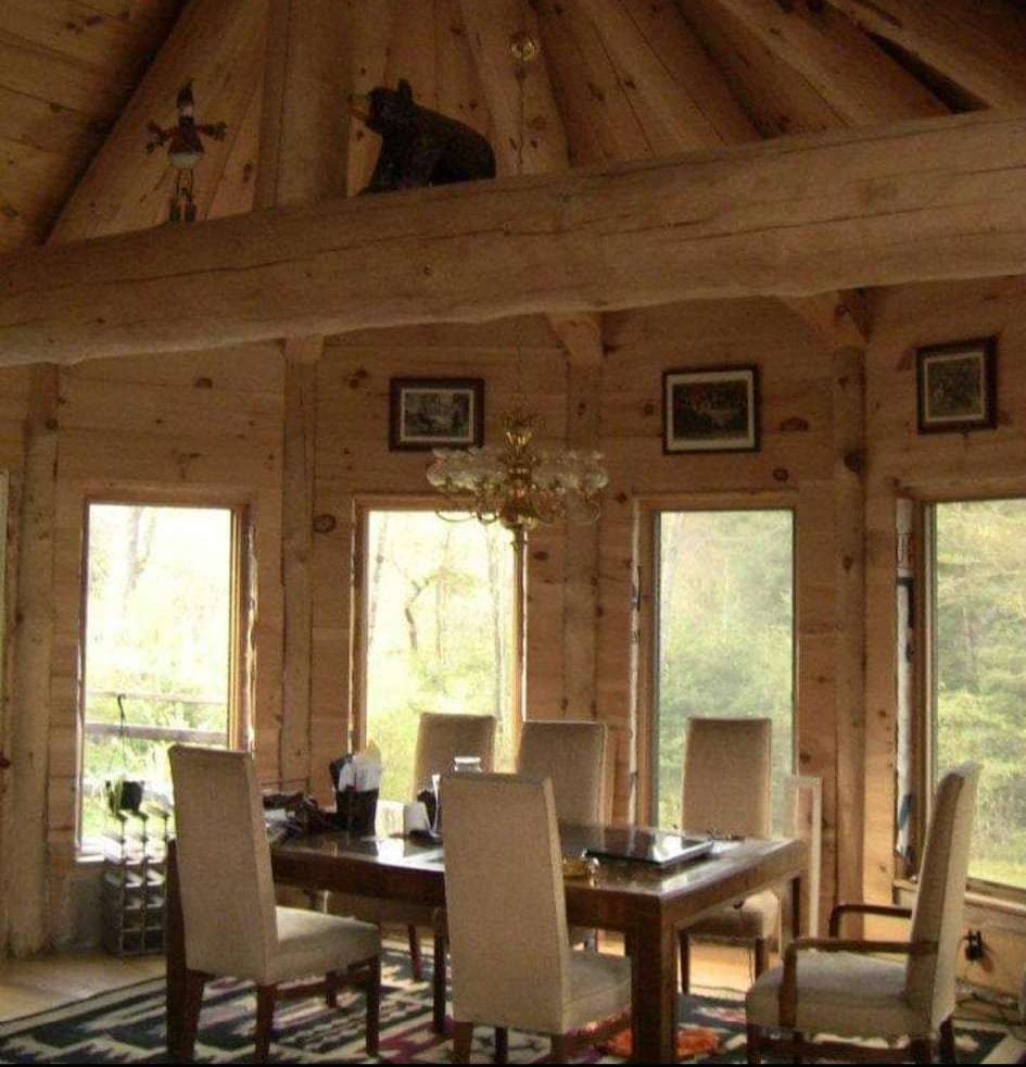 Handcrafted log home dining room with vaulted ceiling